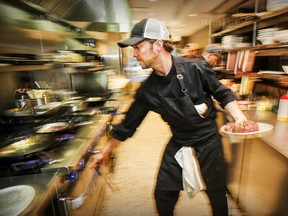 Chef/owner Pascal Turgeon adjusts the temperature of the stove in the kitchen at Tandem in Villeray June 6, 2018.