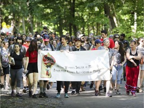 People participating in the Native Women's Shelter's annual Spirit Walk make their way up Mount Royal in Montreal Saturday, June 16, 2018.  The walk is held to raise funds for the shelter.