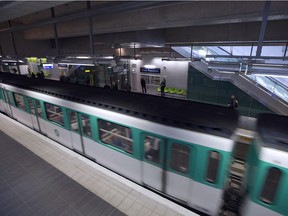 A metro train leaves the Front Populaire subway station on its inauguration day on December 18, 2012 in Aubervilliers-Saint-Denis, north of Paris. AFP PHOTO / JOEL SAGET