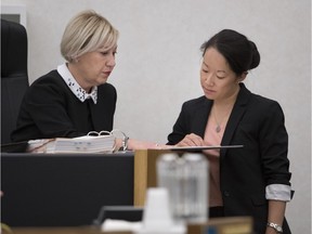 Lead coroner Andree Kronstrom, left, prepares to open an inquest in to the June 2016 death of Mario-Nelson Boucher at a Montreal men's shelter.