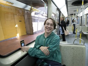 David Vaillancourt uses his phone to film a video aboard the MR-63 métro train's final run on the Green Line on Tuesday, June 19, 2018. There will be runs on all the lines through Thursday. (Allen McInnis / MONTREAL GAZETTE)