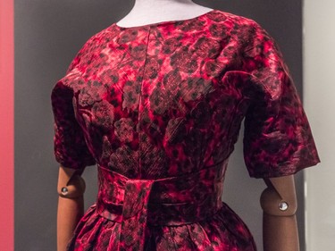 A cocktail dress in silk by Cristóbal Balenciaga, 1958. Balenciaga adopts a kimono sleeve in this dress and a wide, obi-style belt. Unlike a kimono, the dress has a defined waist. Balenciaga was introduced to the Japanese kimono by the French designer Madeleine Vionnet, who hung Japanese prints in her studio and was inspired by non-Western fashion.