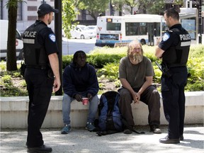 “There is no question we have to be more sensitive in many matters,” says Sgt. Christopher Brault, 43, right, with Const. Carlos Montesinos, on patrol in Cabot Square. “We are getting better training on understanding different cultures and backgrounds and on properly intervening." (Allen McInnis / MONTREAL GAZETTE)