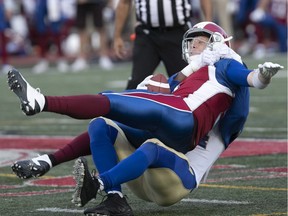 Montreal Alouettes quarterback Drew Willy (5) is sacked by Winnipeg Blue Bombers's Tristan Okpalaugo (54) second quarter action, during CFL game at Molson Stadium on Friday June 22, 2018.