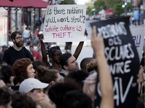 Protesters rally outside a presentation of SLĀV at Théâtre du Nouveau Monde on June 26.