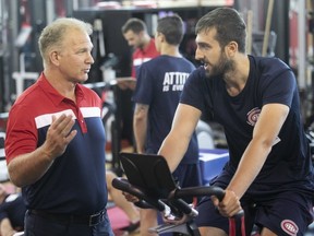 Montreal Canadiens director of player personnel Rob Ramage, left, speaks with prospect Michal Moravcik, on a stationary bike, during Day 1 of team's development camp on Thursday, June 28, 2018, in Brossard.