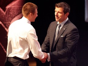 Alex Galchenyuk, third overall pick by the Montreal Canadiens, shakes hands with general manager Marc Bergevin on stage during the 2012 NHL Entry Draft at Consol Energy Center on June 22, 2012, in Pittsburgh.