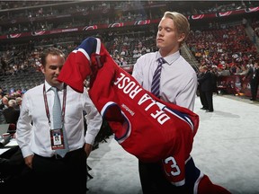 Jacob De la Rose tries on Canadiens sweater in front of team owner/president Geoff Molson after being selected in the second round (34th overall) at the 2013 NHL Draft in New Jersey.