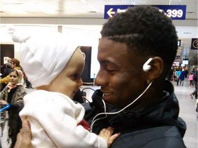 The 19-year-old convicted of killing Darius Brown, pictured holding a young relative at Trudeau airport, was sentenced to two years in a youth detention centre and one year of supervised release.