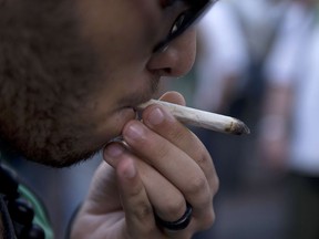 A man smokes a joint — in public.