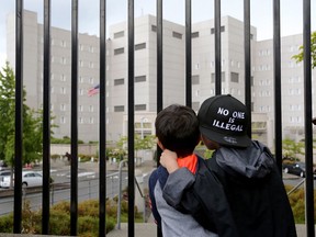 Javier Tapia (left), age 5, and his brother, Charlie Tapia, age 7, from Seattle, look at a Federal Detention Center holding migrant women on June 9, 2018, in SeaTac, Washington. The boys, whose family is originally from Mexico, were there as part of a protest.