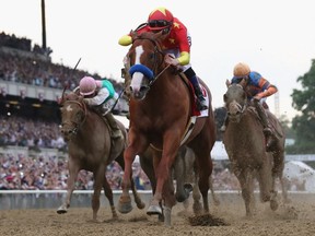 Justify (1), ridden by jockey Mike Smith crosses the finish line to win the 150th running of the Belmont Stakes at Belmont Park on June 9, 2018, in Elmont, N.Y.. Justify was the 13th Triple Crown winner and the first since American Pharoah in 2015.