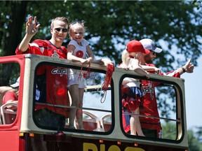 Washington Capitals center Lars Eller (left) and goaltender Braden Holtby hold their daughters during Stanley Cup victory parade in Washington on June 12, 2018.