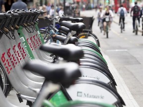 Bixi is the third largest bike-sharing system in North America, the city says. Last year, it added 1,000 bikes, 80 stations and 2,214 bike stands. Allen McInnis / MONTREAL GAZETTE

MONTREAL, QUE.: MAY 25, 2018 -- Bixi bikes line the sidewalk as cyclist use the bike path on de Maisonneuve street in Montreal, on Friday, May 25, 2018. (Allen McInnis / MONTREAL GAZETTE) ORG XMIT: 60