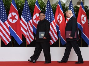 President Donald Trump walks out with North Korea's leader Kim Jong Un after taking part in a signing ceremony at the end of their historic US-North Korea summit, at the Capella Hotel on Sentosa island in Singapore on June 12, 2018.