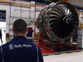 This file photo taken on November 30, 2016 shows a Rolls Royce Trent XWB engine on view on the assembly line at the Rolls Royce factory in Derby, central England. Rolls-Royce, the British maker of plane engines, said on June 13, 2018 that it plans to cut 4,600 mainly British jobs by 2020, adding to thousands of  cuts already announced in recent years.