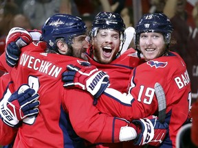 Washington Capitals defenceman John Carlson, centre, celebrates his goal against the Vegas Golden Knights with Alex Ovechkin, left, of Russia, and Nicklas Backstrom, right, of Sweden, during the second period in Game 4 of the NHL hockey Stanley Cup Final, Monday, June 4, 2018, in Washington.