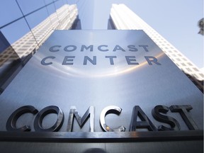 This March 29, 2017, file photo shows a sign outside the Comcast Center in Philadelphia. Comcast made a $65 billion bid Wednesday for Fox's entertainment businesses, setting up a battle with Disney to become the next mega-media company.