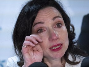 Martine Ouellet wipes a tear during a news conference in Montreal on Monday, June 4, 2018. Ouellet announced she is stepping down as head of the Bloc Quebecois after a resounding defeat in a weekend leadership vote.