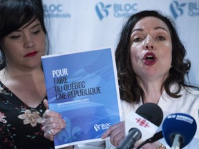 Martine Ouellet holds up her party program during a news conference in Montreal on Monday, June 4, 2018.