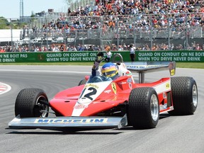 Former Formula 1 racer Jacques Villeneuve drives his father Gilles Villeneuve's 1978 Ferrari during the drivers' parade prior to the Canadian Grand Prix Sunday, June 10, 2018 in Montreal.