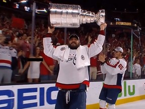 During Thursday's Stanley Cup celebration, a woman in a white dress flashes the team. Alex Ovechkin doesn't seem to notice or care.