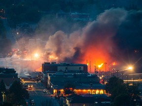 Smoke and fire rises at night over the town of Lac-Megantic after a train carrying crude oil derailed and exploded in the town of Lac-Megantic, 100 kilometres east of Sherbrooke on Saturday, July 6, 2013.