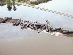 In this aerial drone image taken from video and provided by the Sioux County Sheriff's Office, tanker cars carrying crude oil are shown derailed about a mile south of Doon, Iowa, on Friday, June 22, 2018. About 31 cars derailed after the tracks reportedly collapsed because of saturation from flood waters from adjacent Little Rock River.