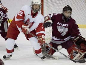 McGill Martlets' Shauna Denis and Ottawa Gee-Gees goaltender Megan Takeda follow puck during McGill's 4-1 win to clinch the 2005-06 QSSF league championship on March 5, 2006.