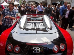 Race fans check out the mid-engine Bugatti Veyron on Peel St in Montreal on Thursday, June 7, 2012 as part of the Canadian Formula One Grand Prix festivities.