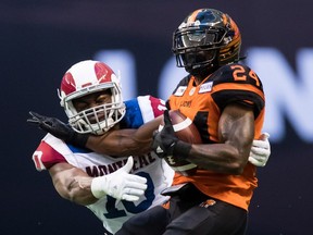 Alouettes middle-linebacker Henoc Muamba tackles Lions' Jeremiah Johnson during season opener on Saturday.  Muamba registered four defensive tackles and another on special teams during the game.