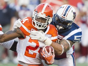 Former Montreal Alouettes defensive end Gabriel Knapton tackles B.C. Lions running back Jeremiah Johnson during first half CFL football action in Montreal, Thursday, July 6, 2017.