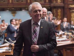 Parti Québécois MNA François Gendron, walks back to his seat as members of the National Assembly applaud for being an elected member for the last 40 years in Quebec City on Tuesday, November 15, 2016.
