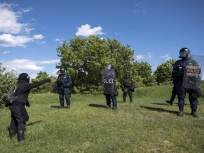 A protester yells at police officers while demonstrating on the Plains of Abraham during the G7 Summit in Quebec City on Friday, June 8, 2018.