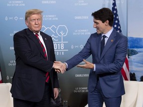 Canada's Prime Minister Justin Trudeau shakes hands with U.S. President Donald Trump during a meeting at the G7 leaders summit in La Malbaie, Que., on Friday, June 8, 2018.