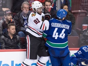 Chicago Blackhawks' Anthony Duclair, left, and Vancouver Canucks' Erik Gudbranson collide during game in Vancouver on Feb. 1, 2018.