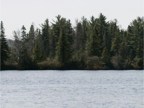 Lantier, Quebec, May 14, 2007.   Environmental officer Brigitte Voss takes pictures of the shoreline of Lac Ludger on Monday, May 14, 2007.  Driving the boat was inspector Sylvain Bazinet.   COPYRIGHT PHOTO BY IAN BARRETT    23255   reporter: Cornacchia  Extra
Lantier environmental officer Brigitte Voss photographs the Lake Ludger shoreline. The photo documentation is one of several municipal measures adopted in the battle against toxic blue-green algae.