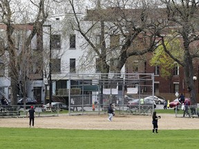 People play in the weekly Wednesday night pick-up softball game on the north diamond at Jeanne-Mance Park in Montreal Wednesday May 10, 2017.