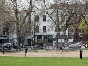 People play in the weekly Wednesday night pick-up softball game on the North Field at Jeanne Mance Park in 2007. The field has been closed for safety reasons and Projet Montréal vows to consult with the public as to the future of the Park.