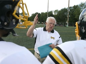 Sun Youth Hornets coach Earl De La Perralle gives his team captains some final advice before a game  in 2007.