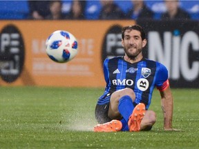 Impact midfielder Ignacio Piatti slips as he kicks the ball during first half MLS action against Orlando City at Saputo Stadium Wednesday night.