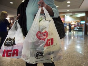 Montreal implemented its long-planned ban on plastic bags on Monday, making it the first major Canadian city to do so. A woman leaves a grocery store in Montreal, Friday, May 15, 2015.
