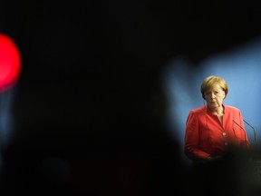 In this photo taken with a red television camera control light in the fore ground, German Chancellor Angela Merkel attends a joint statement with the Prime Minister of Italy Giuseppe Conte prior to talks at the chancellery in Berlin, Monday, June 18, 2018.