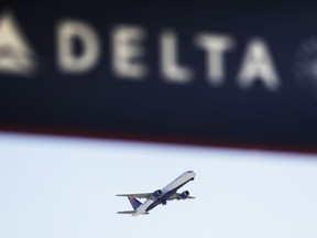 FILE - In this Jan. 30, 2017, file photo, a Delta Air Lines flight takes off from Hartsfield-Jackson International Airport in Atlanta. Authorities said Tuesday, June 26, 2018, they've arrested a 19-year-old man accused of sprinting shirtless toward a jet at the airport and jumping on the wing. (AP Photo/David Goldman, File)