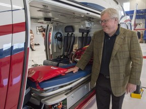 Quebec Health Minister Gaetan Barrette looks in the cabin of an air ambulance after announcing a pilot project for provincial helicopter ambulance services in Longueuil, Que., Friday, June 22, 2018.