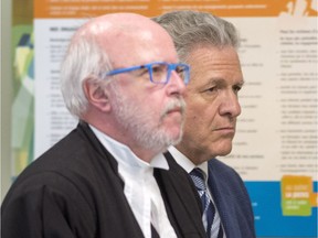 Former construction magnate Tony Accurso, right, and his lawyer, Marc Labelle, walk to the courtroom for his sentencing hearing June 28, 2018 in Laval. Accurso was found guilty on all five charges he was facing, including fraud and corruption.