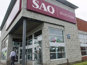 A man leaves an SAQ outlet on Monday, June 18, 2018 in Montreal.