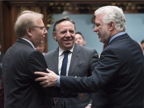 Quebec Premier Philippe Couillard, right, Parti Québécois leader Jean-François Lisée, left, and Coalition Avenir Québec leader François Legault greet each other as the legislature comes to an end on Friday.