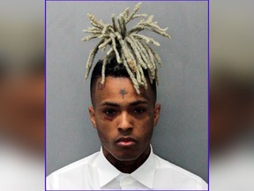 This 2017 arrest photo made available by the Miami Dade Dept. of Corrections shows Jahseh Onfroy, also known as the rapper XXXTentacion, under arrest. Onfroy was shot and killed, Monday, June 18, 2018, in Deerfield Beach, Fla.