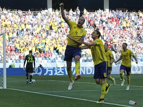 Sweden's Andreas Granqvist, centre, celebrates after scoring the opening goal during the group F match between Sweden and South Korea at the 2018 soccer World Cup in the Nizhny Novgorod stadium in Nizhny Novgorod, Russia, Monday, June 18, 2018.